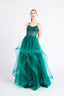 Woman wearing a green Ballgown with a white background