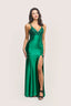 Woman wearing a green evening gown with a slit on a white background