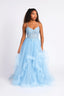 Woman wearing a light blue Ballgown with a white background