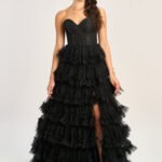Showcasing 2025 formal fashion trends in satin with contemporary accents, this elegant black ball gown from the UK was worn on the red carpet.