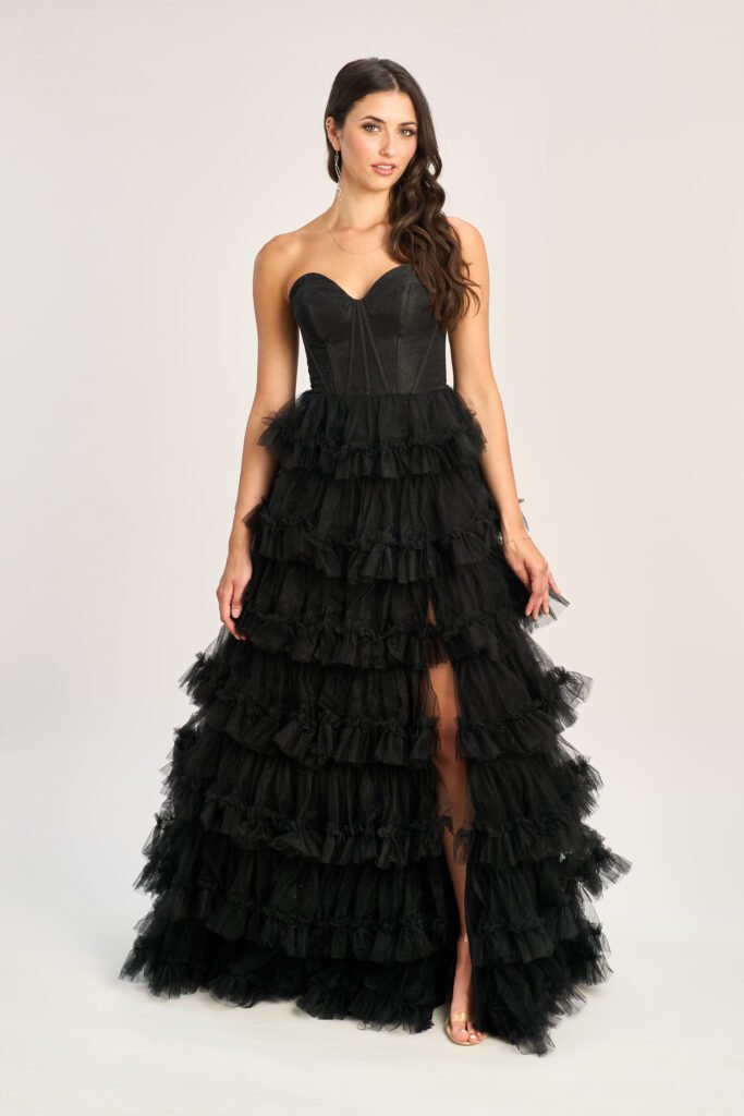 Showcasing 2025 formal fashion trends in satin with contemporary accents, this elegant black ball gown from the UK was worn on the red carpet.