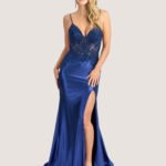 Model wears Jora Shami Y40270 blue evening gown with embroidered skirt.
