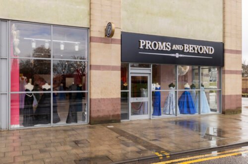 Elegant teen trying on stylish ball gown — dress ideas for prom inspiration.